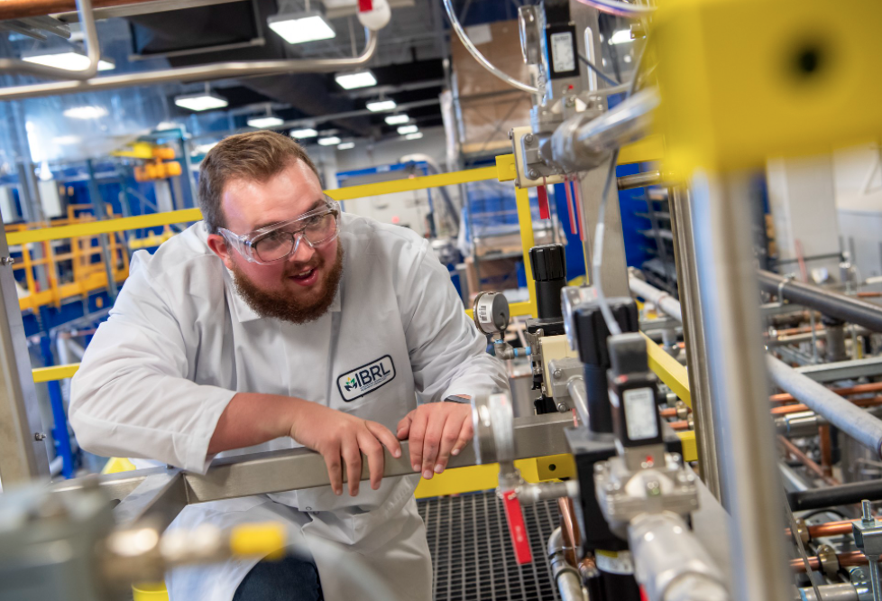 Student running machinery at IBRL.