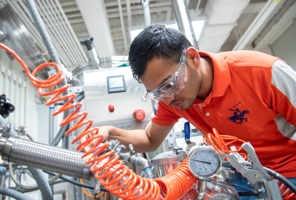 Student running machinery at IBRL.